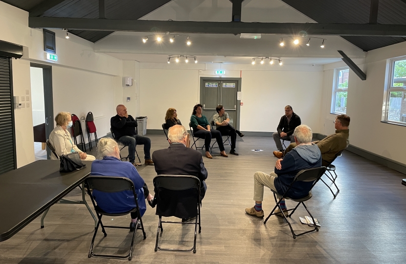 Mark speaking in a circle with residents