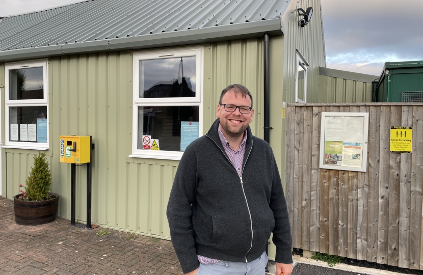 Mark smiling outside the village hall after the meeting.