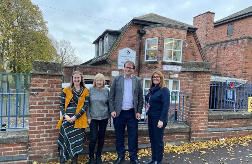 Outside the school with headteacher and two  of the school governors