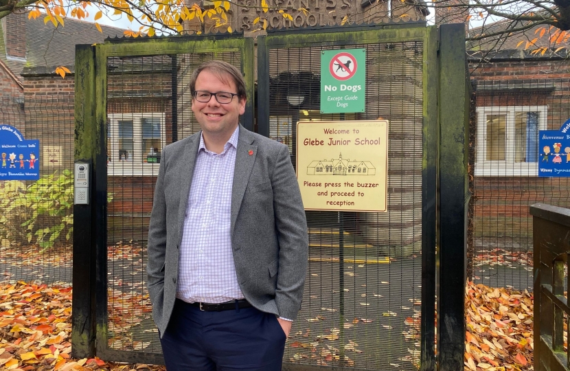 Mark standing by Glebe Junior School Sign