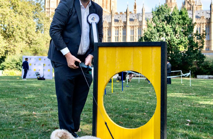 Mark with one dog by an agility tunnel