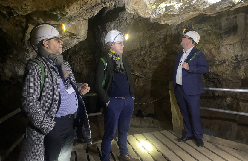 Three men in a cave