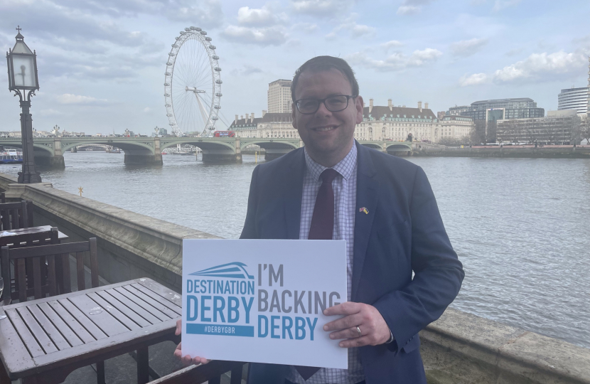 Mark on the terrace holding Destination Derby sign