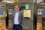 Mark standing by Glebe Junior School Sign