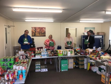 Mark Fletcher, new County Councillor James Barron and volunteers at the Tibshelf food bank.