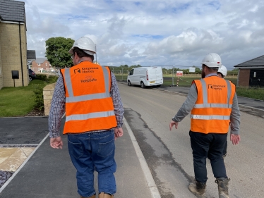 Mark Fletcher in High Vis jacket and speaking to keepmoat homes developers