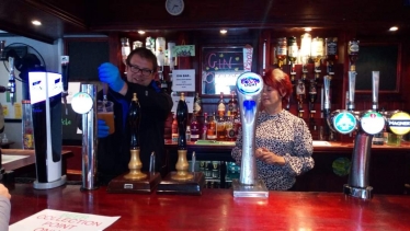 Mark Fletcher MP pours a pint under Kay Towers' tutelage