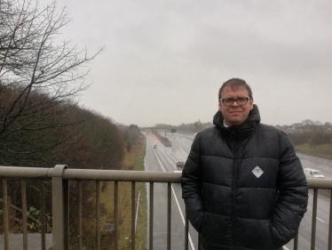 Mark standing on Ball Hill Bridge overlooking J28 slip road