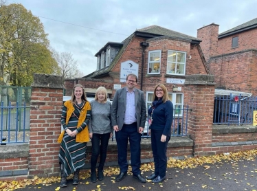 Outside the school with headteacher and two  of the school governors