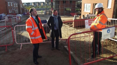 Christopher Pincher MP talking to workers on building site