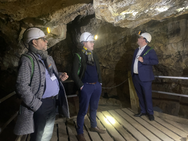 Three men in a cave