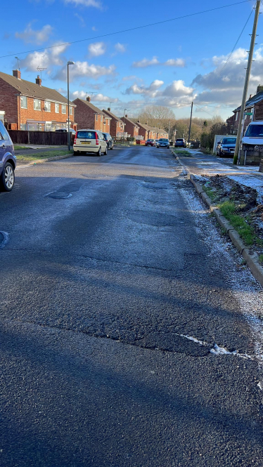 road with potholes that have been fixed recently